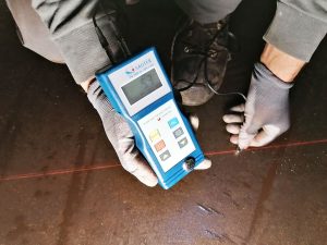 Durchführung der Schichtdickenmessung entlang der Netzgitter und Dokumentation durch den Monteur – Prüfung der Wandung am Tankboden